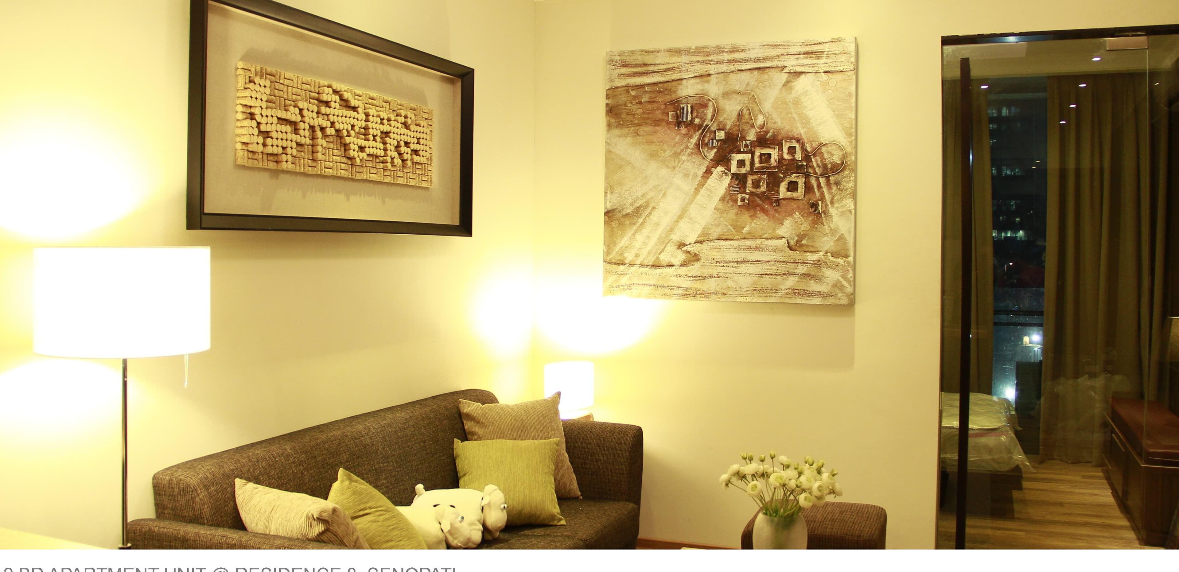 2BR Apartment Unit, Residence 8 Senopati — living room with wall art.